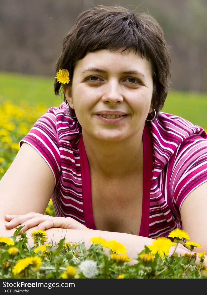 Young woman lying in a meadow