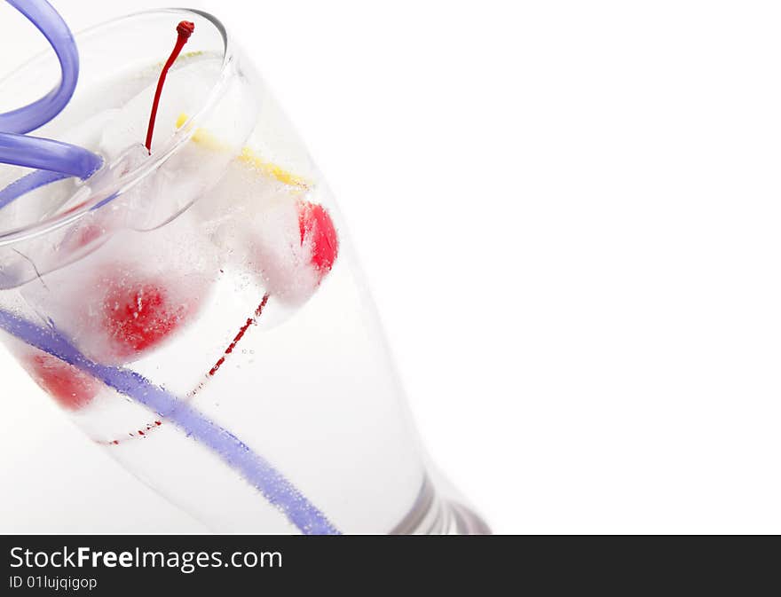 Glass of water with frozen fruit inside the ice cube. Glass of water with frozen fruit inside the ice cube