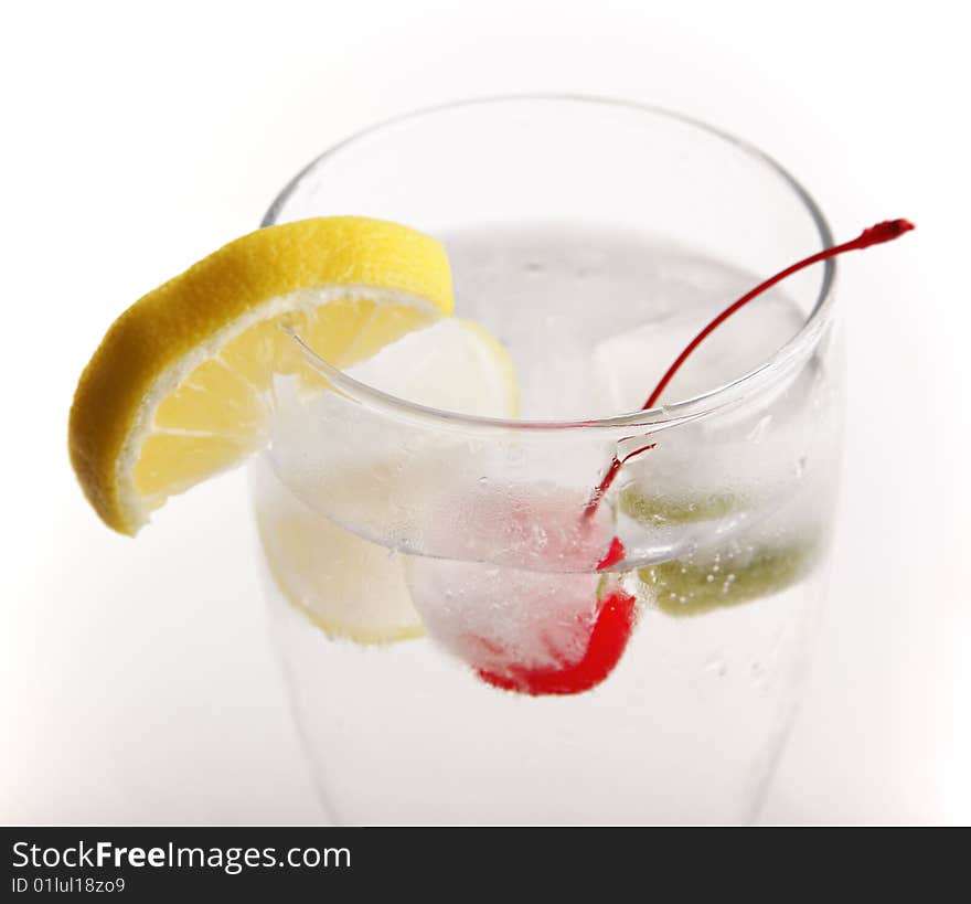 Glass of water with frozen fruit inside the ice cube. Glass of water with frozen fruit inside the ice cube