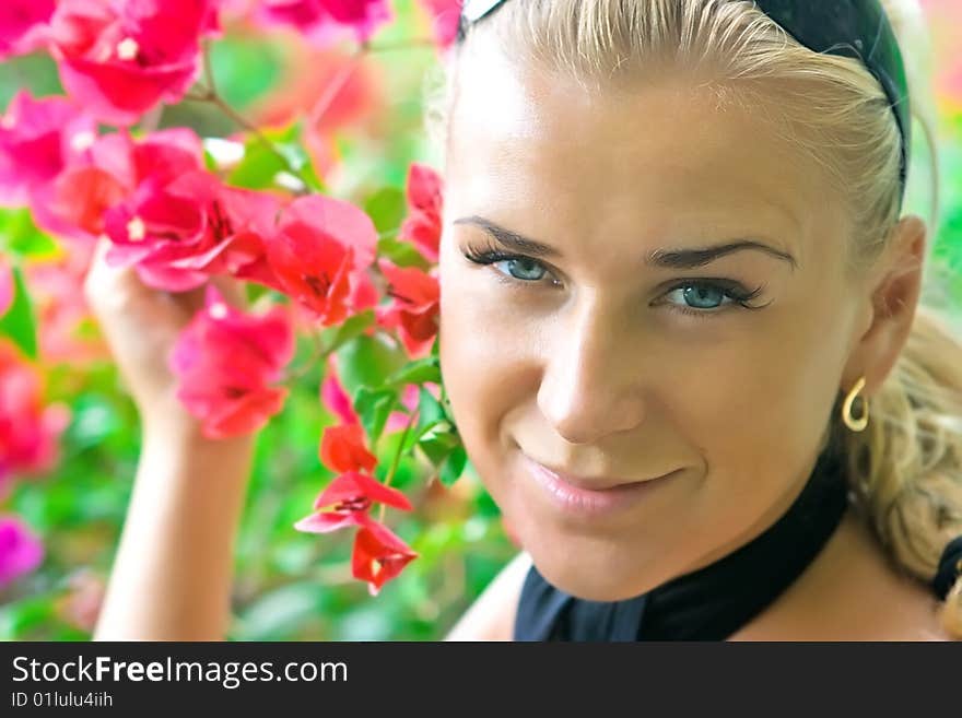 Close-up outdoor shot of a model with flowers. Close-up outdoor shot of a model with flowers