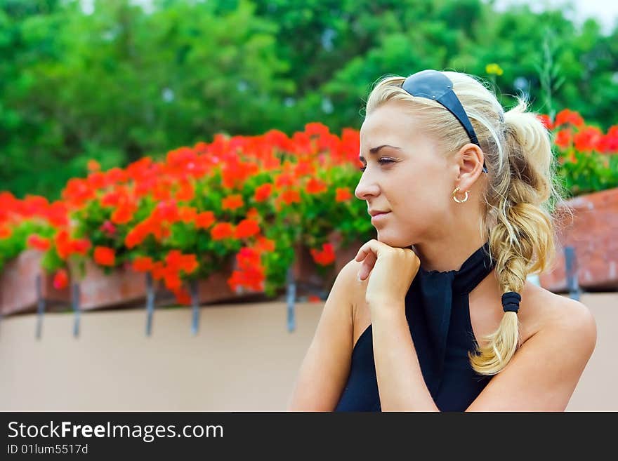 Girl in the park of tropical flowers