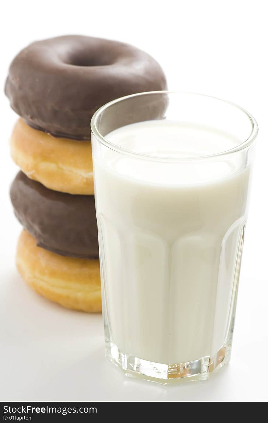 Breakfast glass of chocolate milk and donut isolated