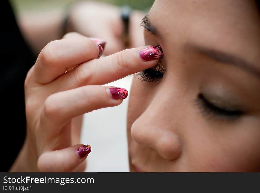 Putting on eye shadow for an event. Putting on eye shadow for an event