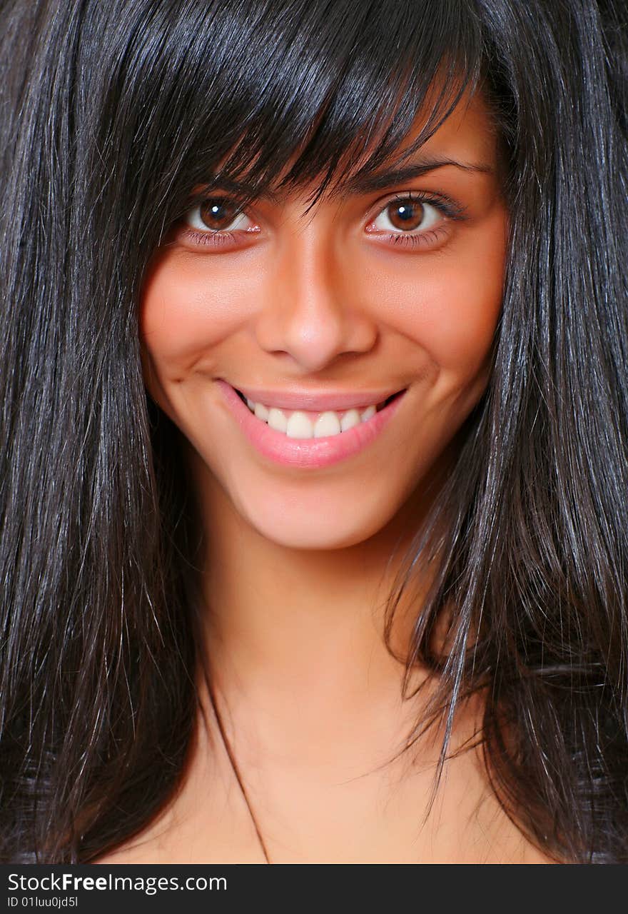 Portrait of the beautiful young woman with magnificent hair and with an open smile, please see some of my other parts of a body images: