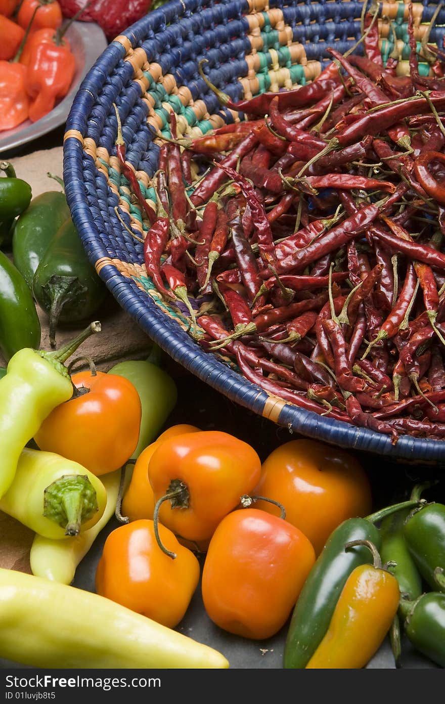 Various Chili Peppers layed out in a studio