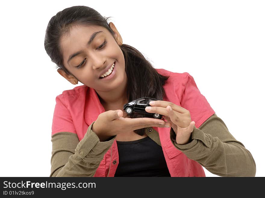 Young girl holding car