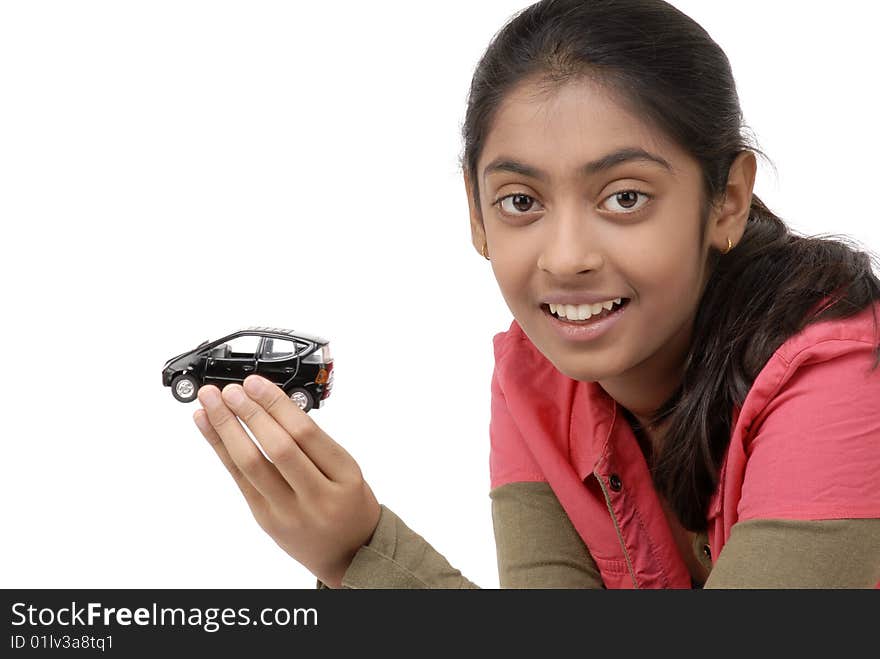 Beautiful girl holding black car model over white background. Beautiful girl holding black car model over white background