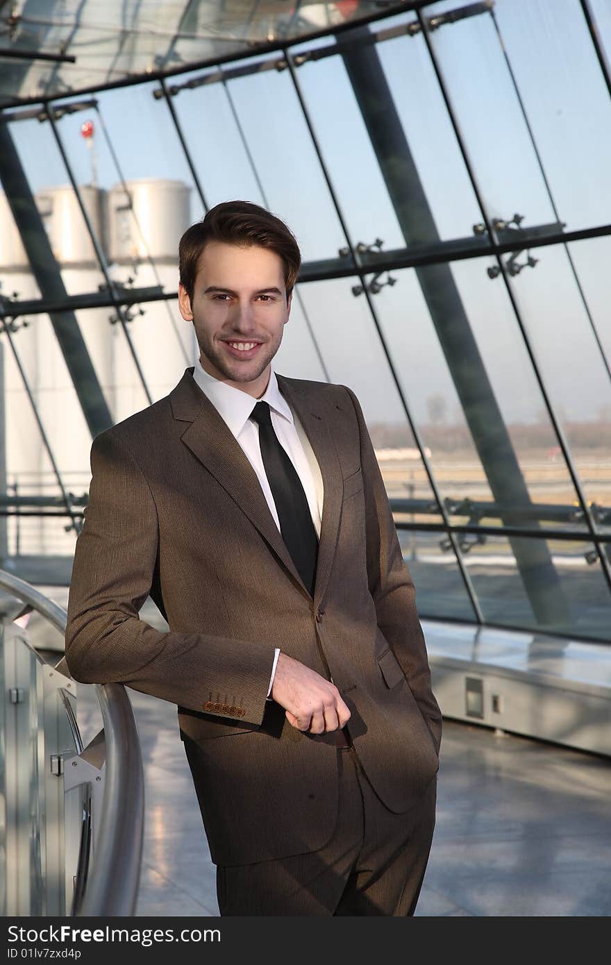 business man is standing and waiting with smiling