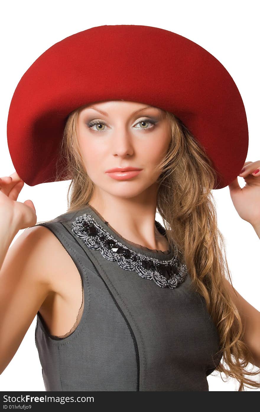 Beautiful young female in red hat isolated over white with clipping path