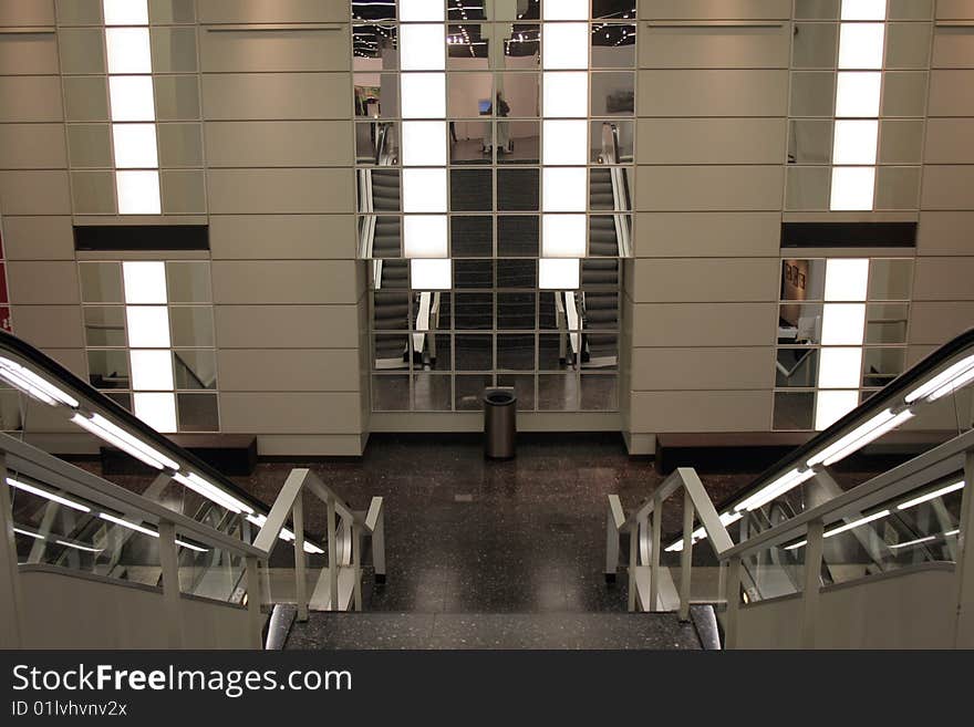 Escalators and stairway mirrored in a modern building