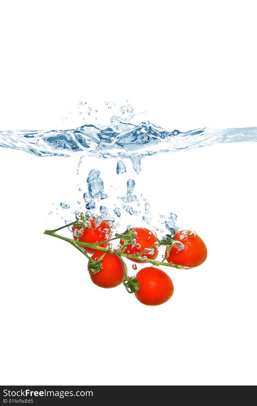 Cherry tomatoes falling into the water