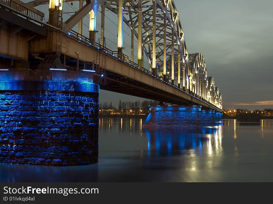 Illuminated Riga Railway bridge over river Daugava at night