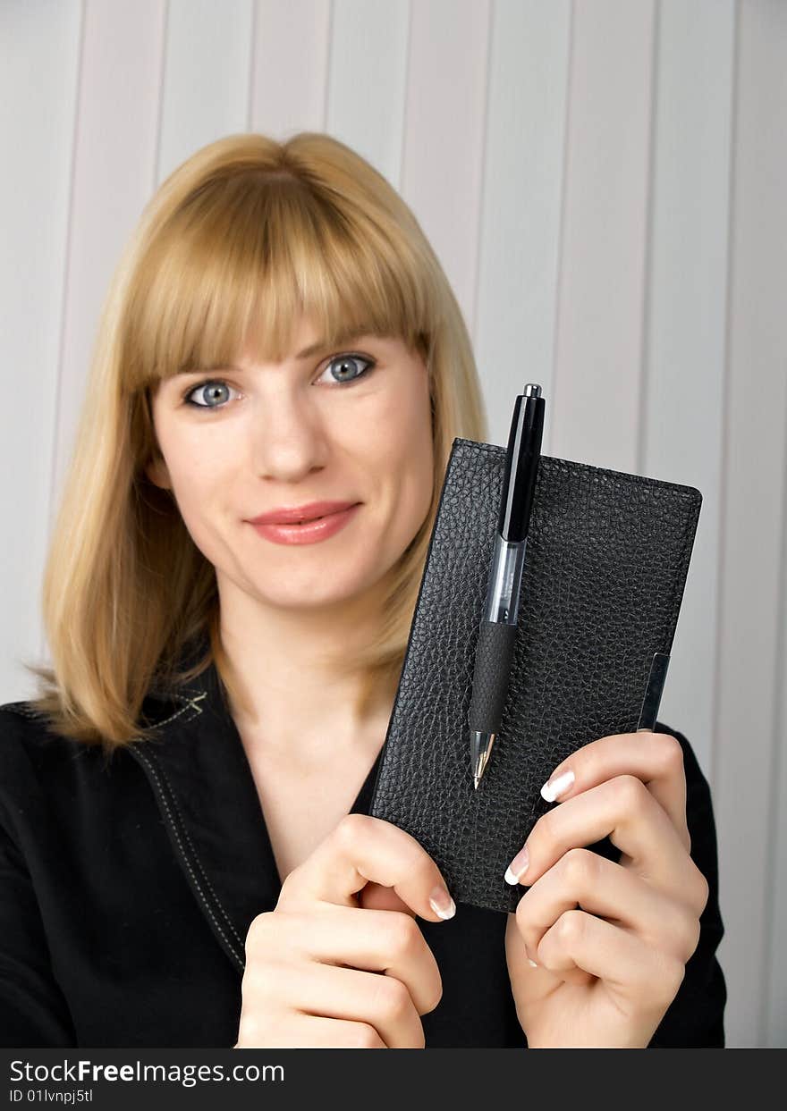 The beautiful businesswoman in a black jacket. The beautiful businesswoman in a black jacket