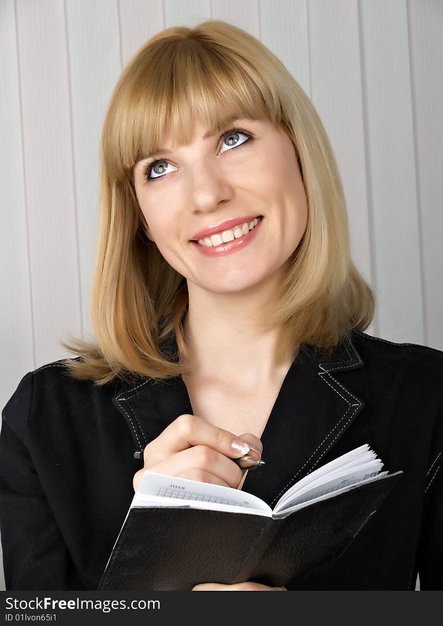 The beautiful businesswoman in a black jacket. The beautiful businesswoman in a black jacket