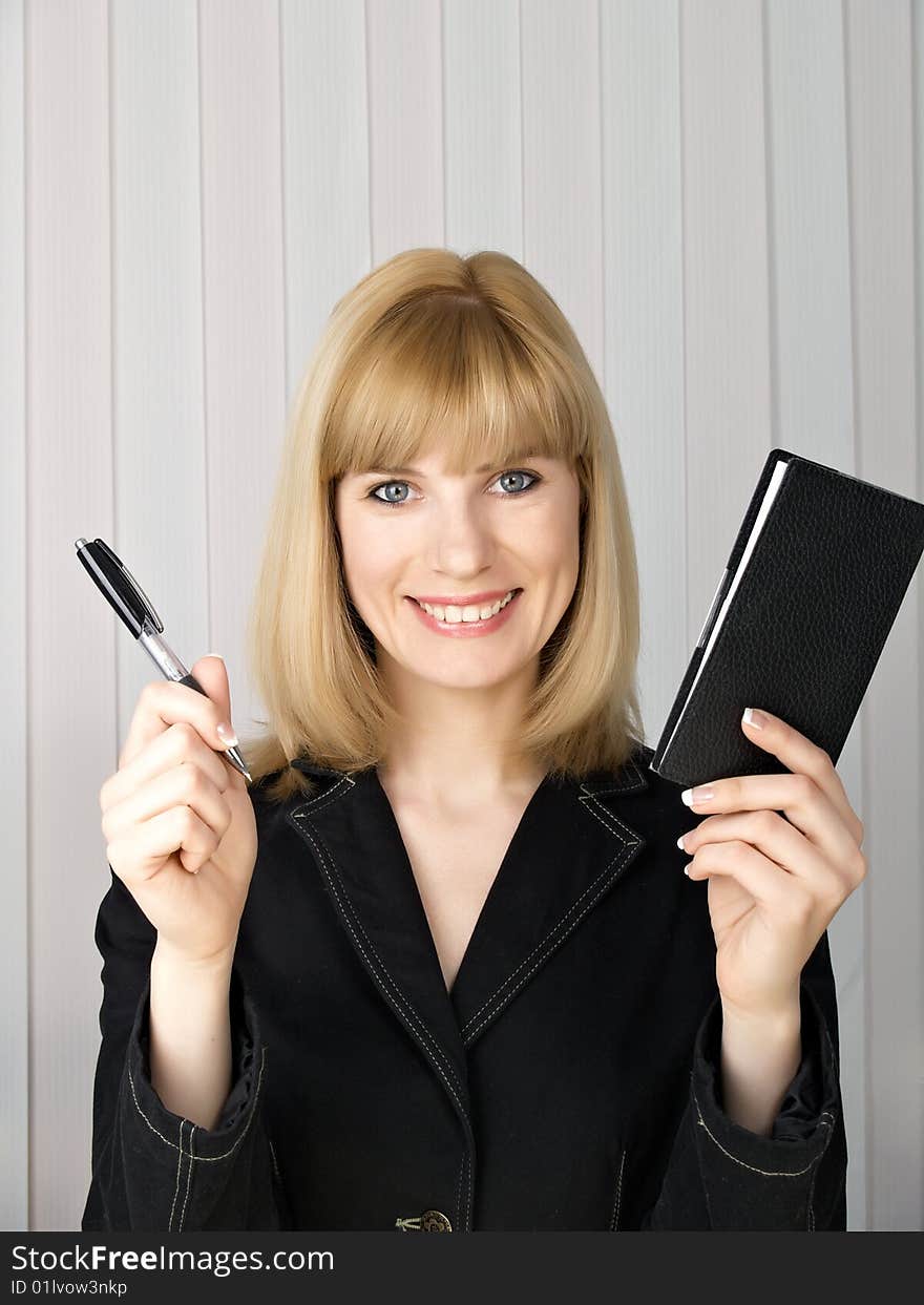 The beautiful businesswoman in a black jacket. The beautiful businesswoman in a black jacket