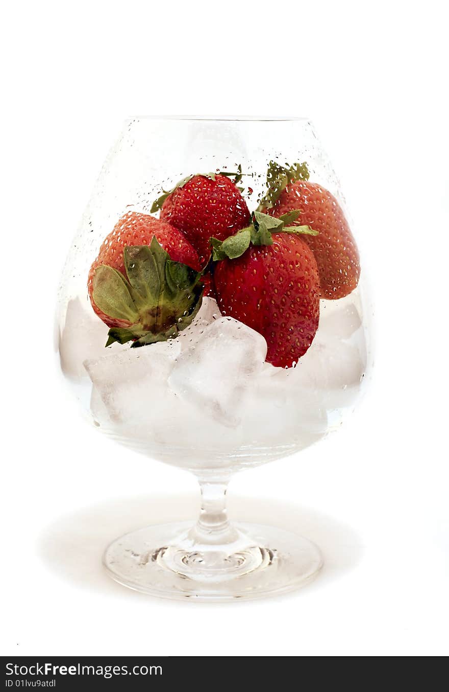 Strawberries in the wet glass isolated on white background