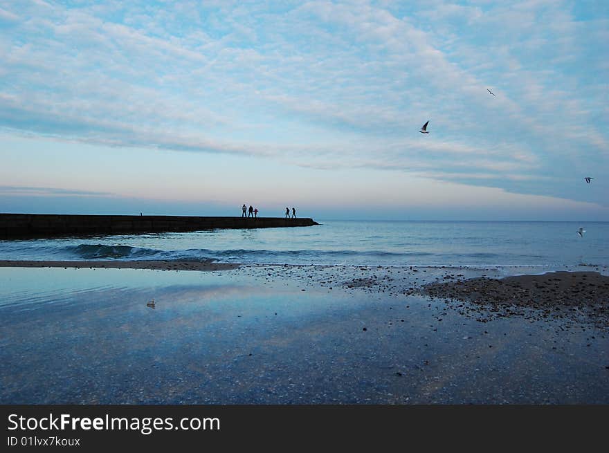 Black sea coast, blue wave and sand