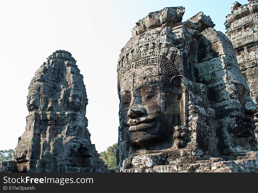 Stone faces on towers of Bayon temple in Angkor Thom, Cambodia. Stone faces on towers of Bayon temple in Angkor Thom, Cambodia