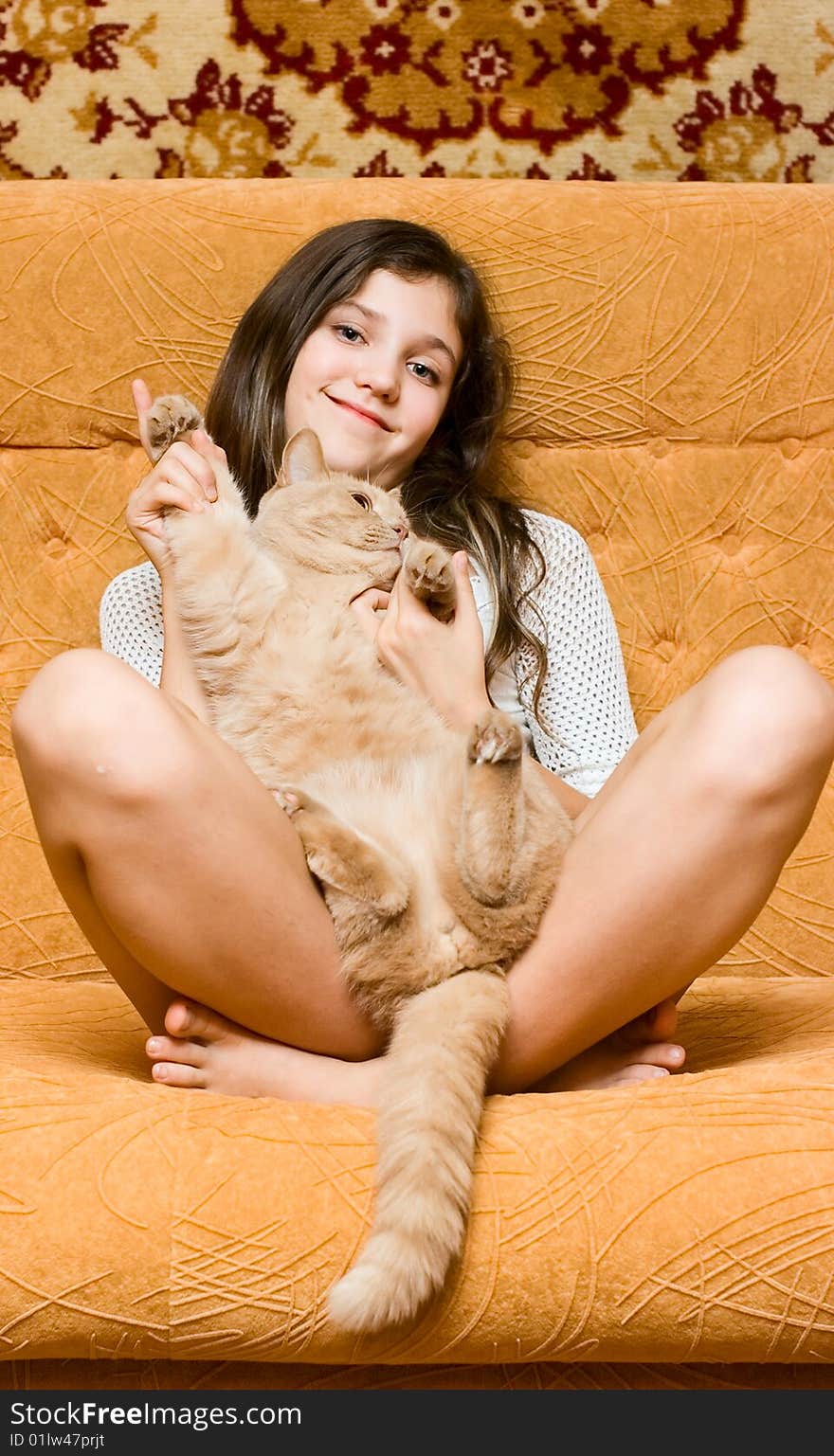 Teen girl and cat on sofa