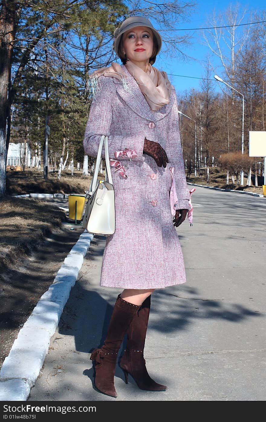 Stylish young woman in coat and lady s hat.