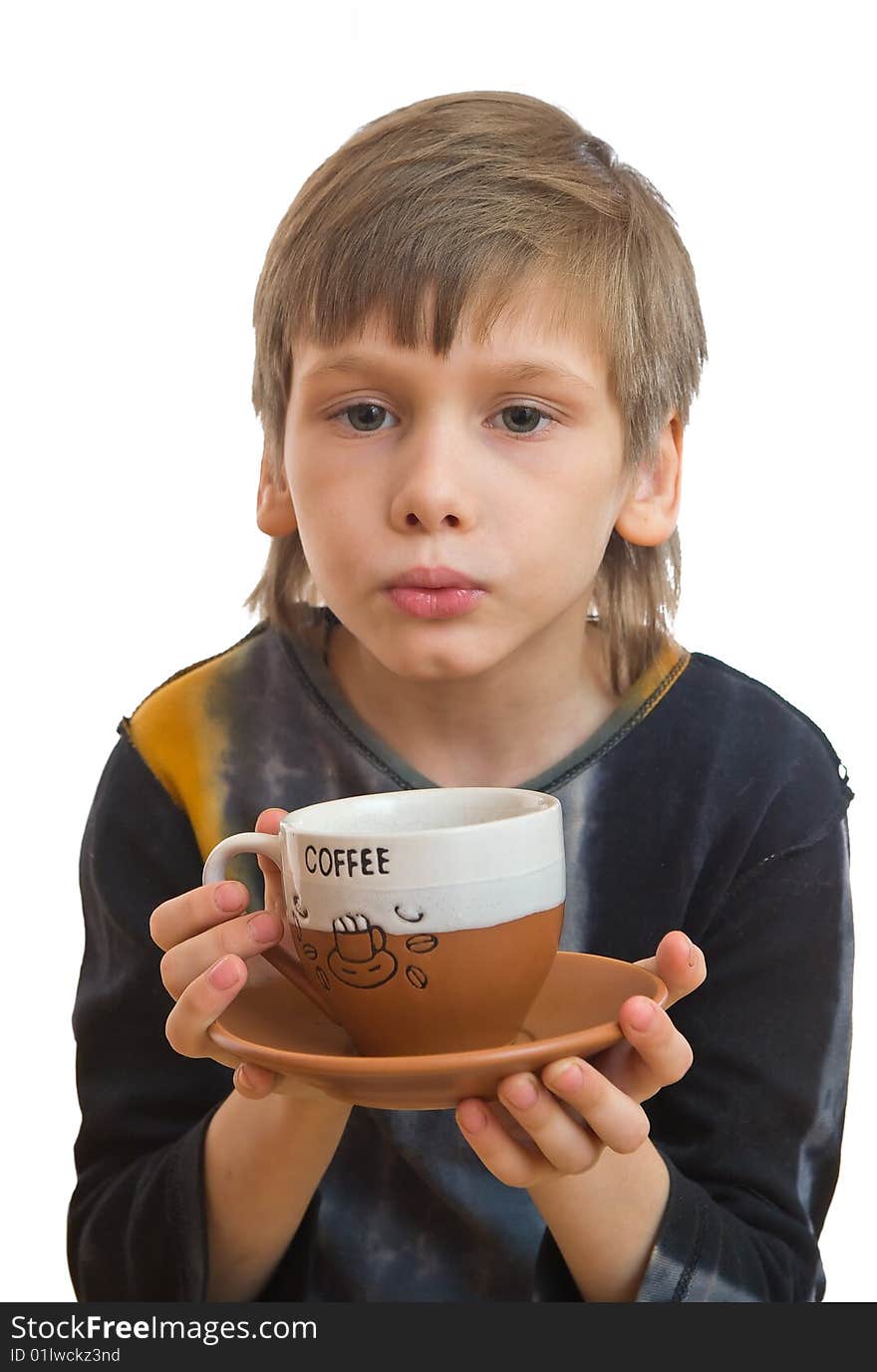 Young boy blow to a cup of coffee in his hand. Young boy blow to a cup of coffee in his hand