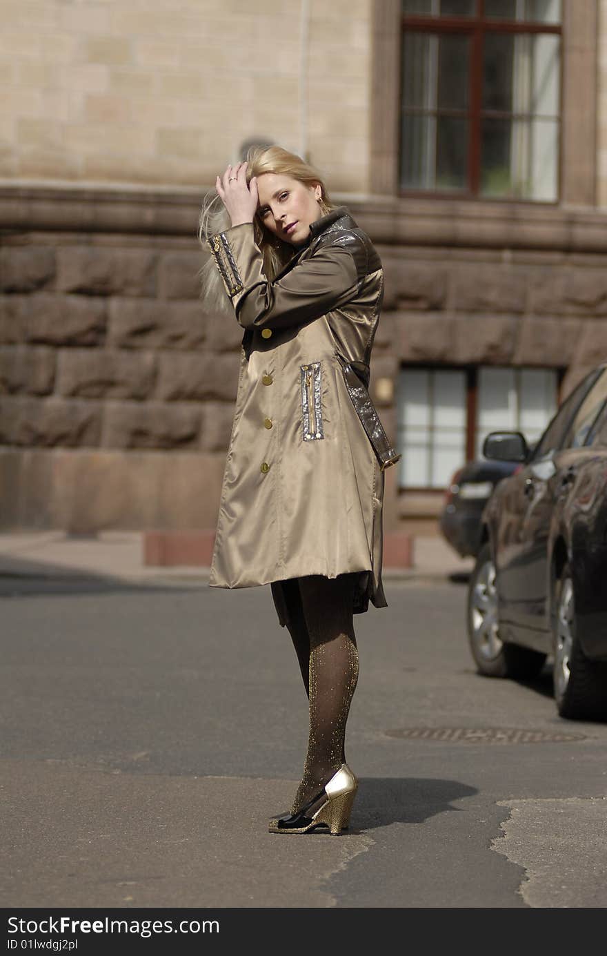 The beautiful blonde on roads catching taxi on a roadside. The beautiful blonde on roads catching taxi on a roadside.