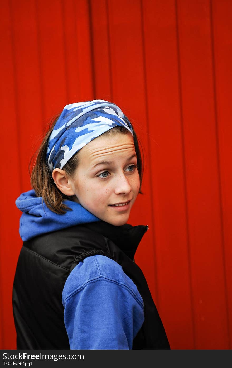 Portrait of pretty girl against red wall