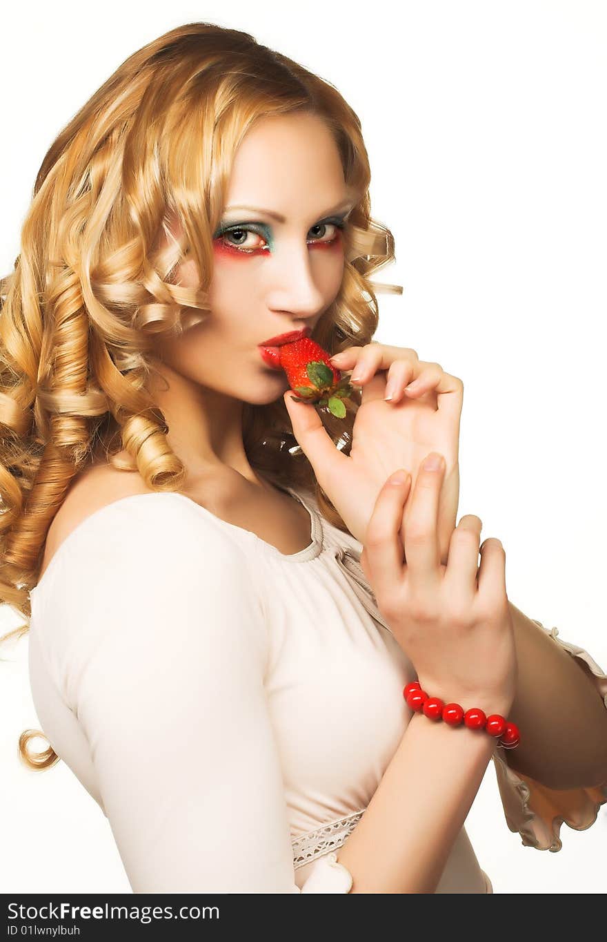 Portrait of pretty blonde with fresh strawberry