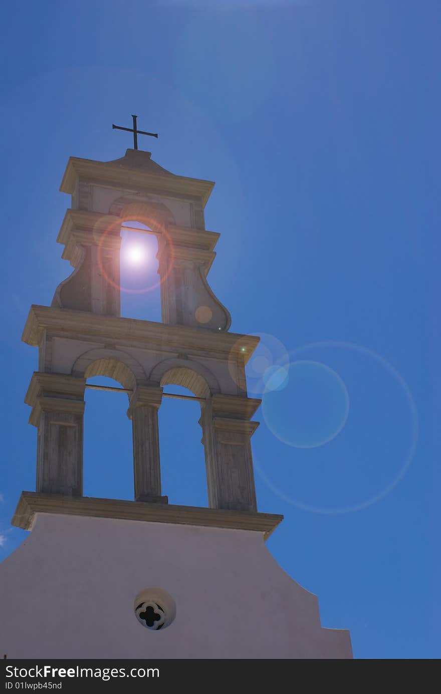 Church steeple in Crete with sun behind it. Good result with lens flare as well