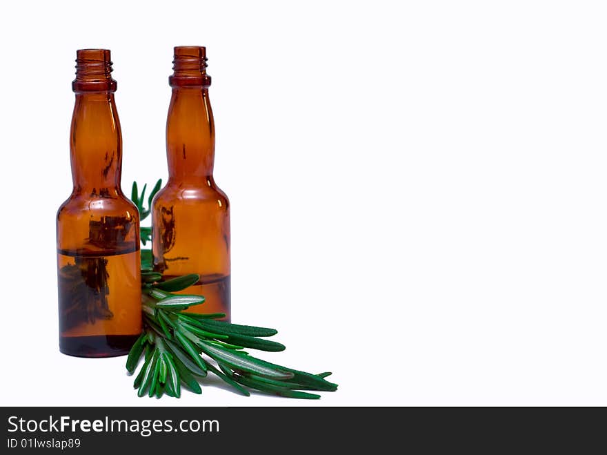 Oil for the body with a sprig of rosemary