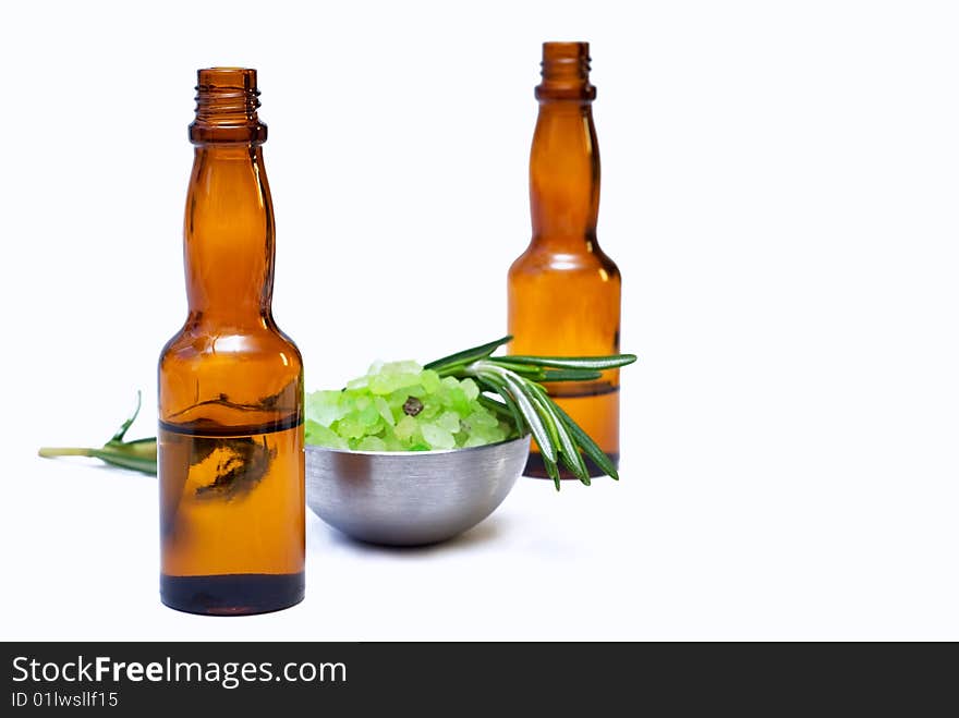 Oil for the body with a sprig of rosemary