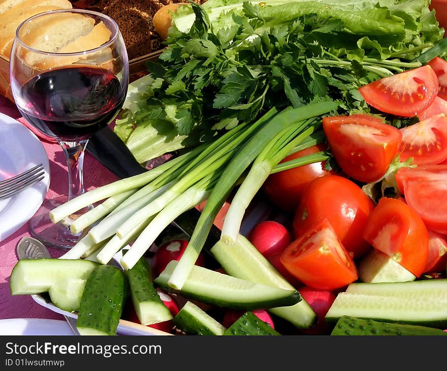 Still life of fresh vegetables - tomatoes, cucumbers, onions on the table. Still life of fresh vegetables - tomatoes, cucumbers, onions on the table