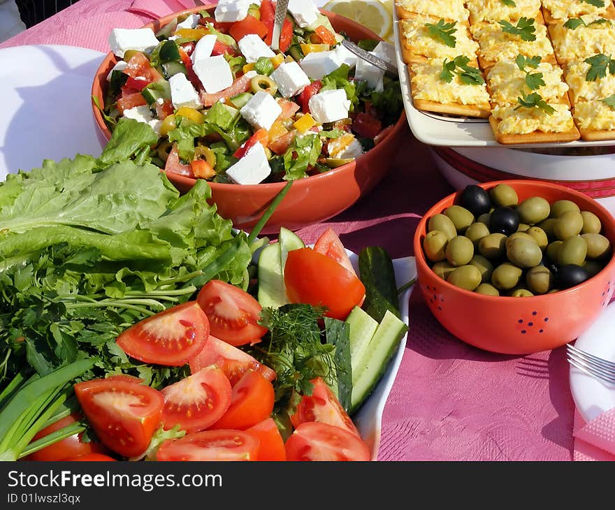 Still life of fresh vegetables - tomatoes, sandwich, cucumbers, onions on the table. Still life of fresh vegetables - tomatoes, sandwich, cucumbers, onions on the table