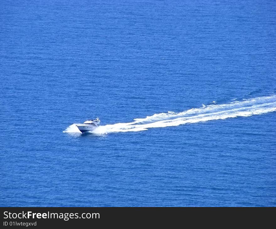 Naval motorboat floats on the high seas clear sunny day