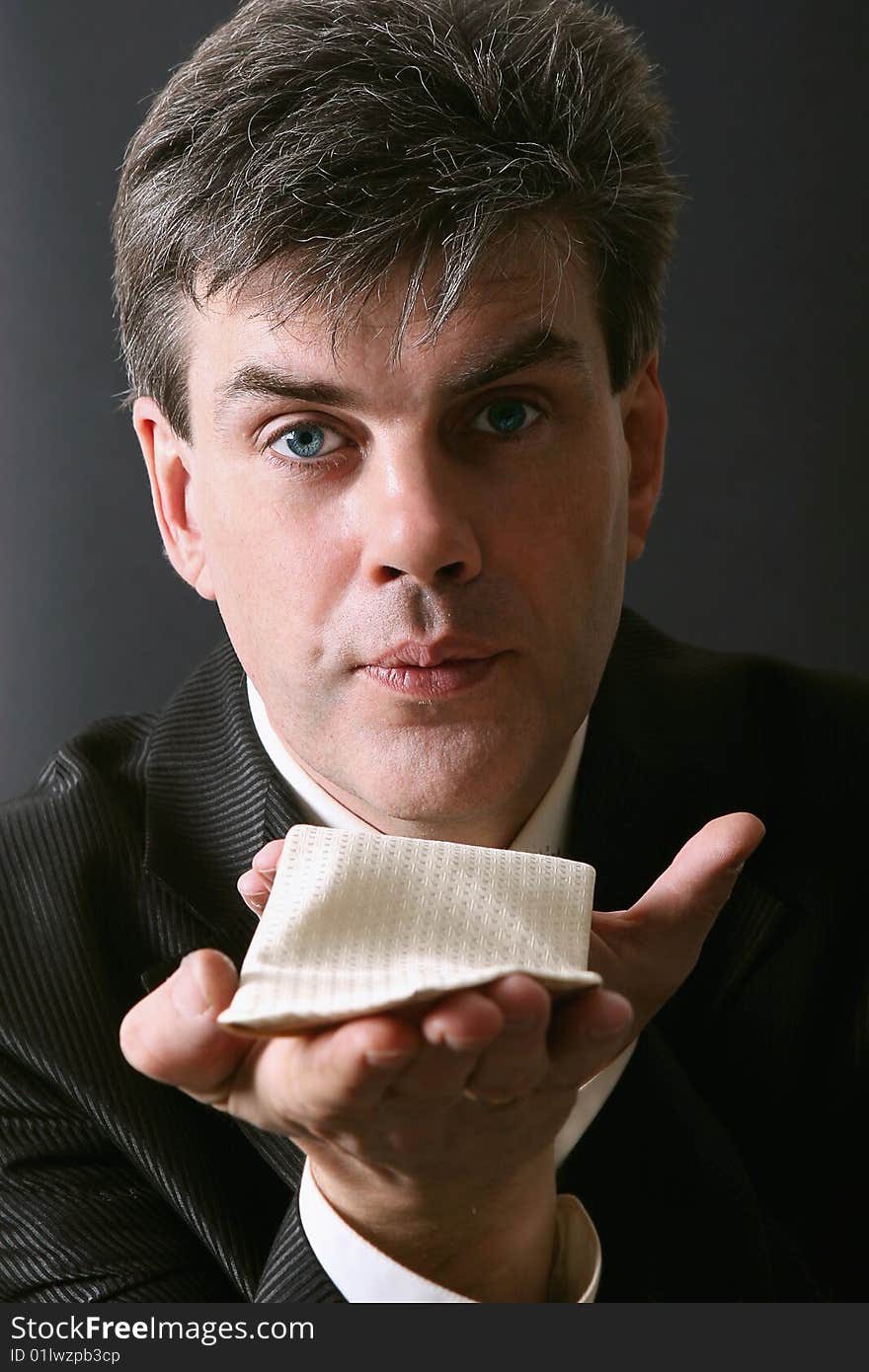 Portrait of a man blowing a kiss. Isolated against gray background. Portrait of a man blowing a kiss. Isolated against gray background