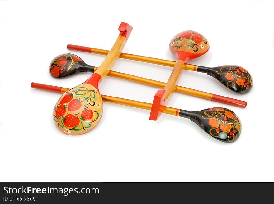 Five Russian wooden hand-painted spoons crossed on white background. Five Russian wooden hand-painted spoons crossed on white background