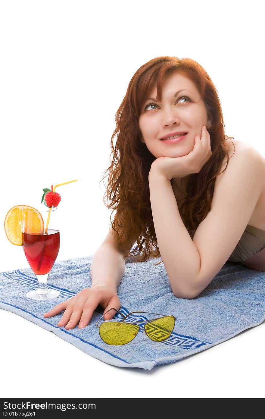 Beautiful girl on a beach towel with a cocktail. Beautiful girl on a beach towel with a cocktail