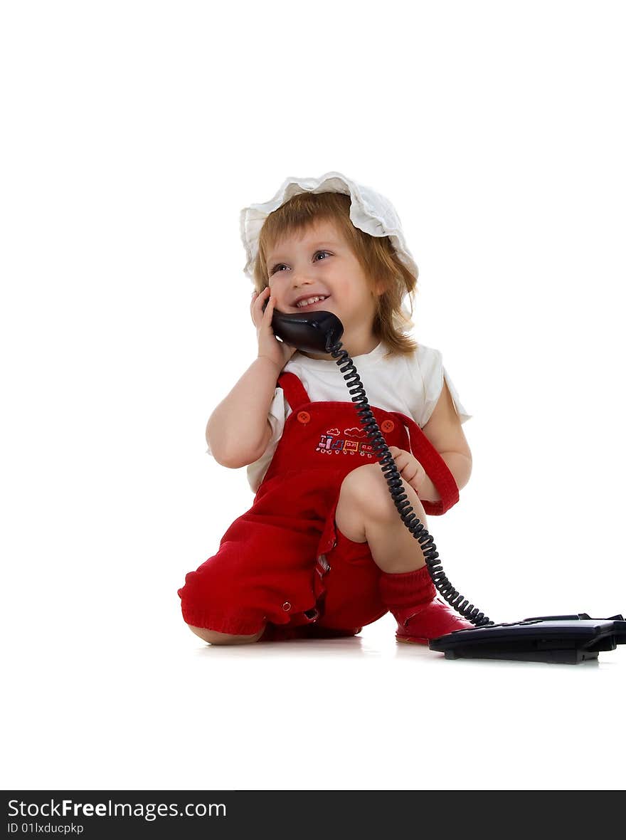 Little girl speaks on the phone. Studio shot. Little girl speaks on the phone. Studio shot