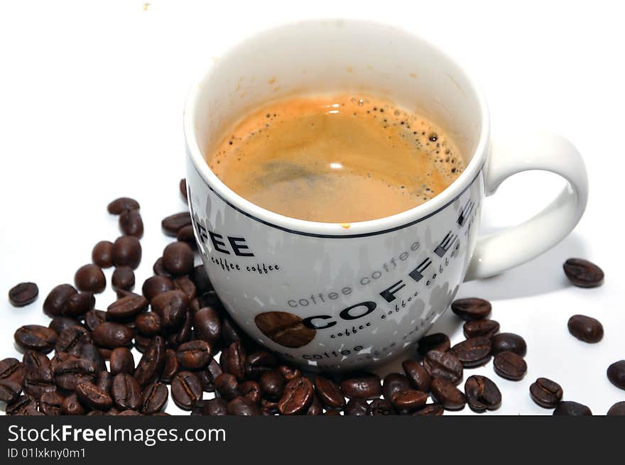 Cup of espresso and coffee beans on a white background. Cup of espresso and coffee beans on a white background