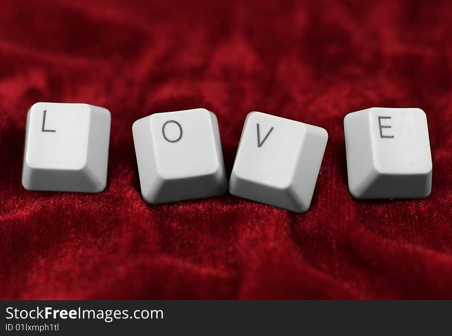 Deep love: keyboard LOVE caption on red cloth