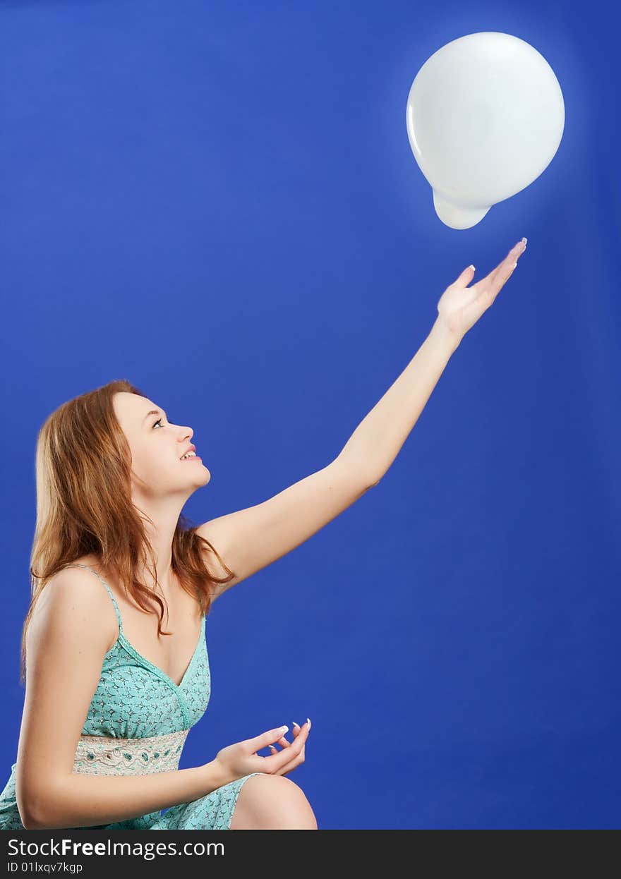 Woman playing with white balloon