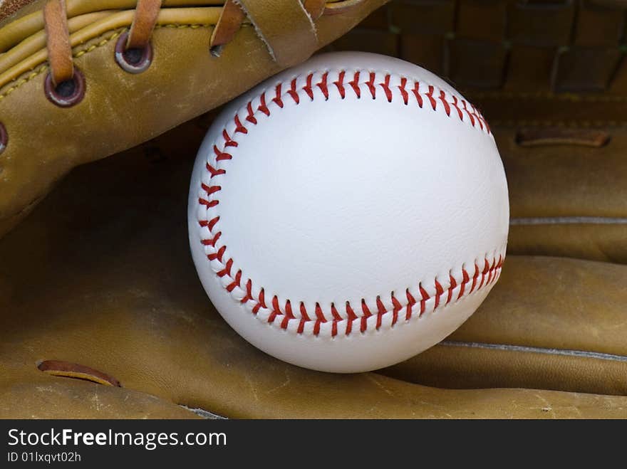 New baseball in an old glove. New baseball in an old glove.