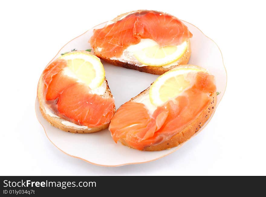 Sandwiches with red fish on a white dish