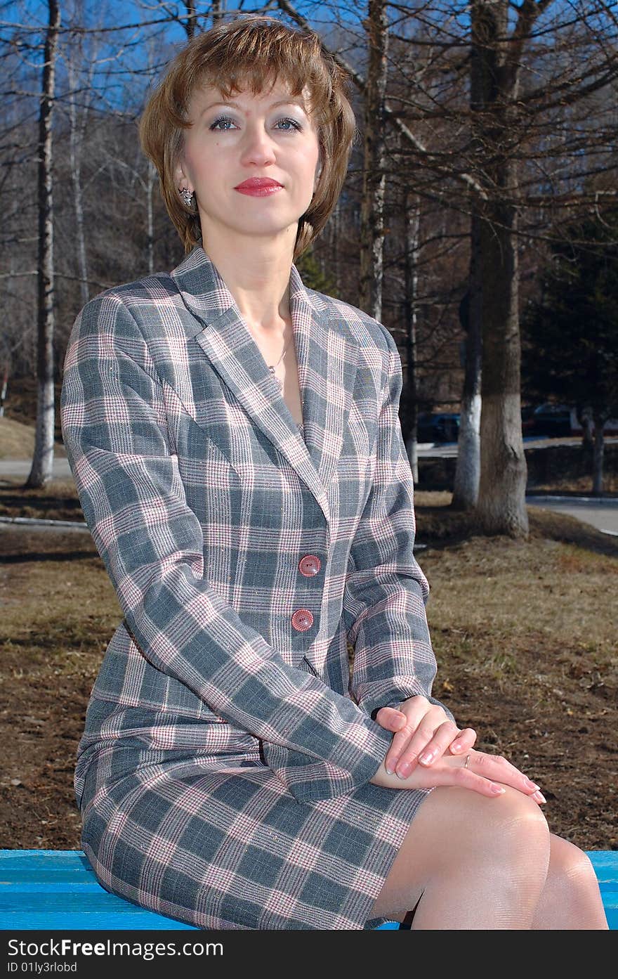 Stylish Young Woman Sit On The Bench.