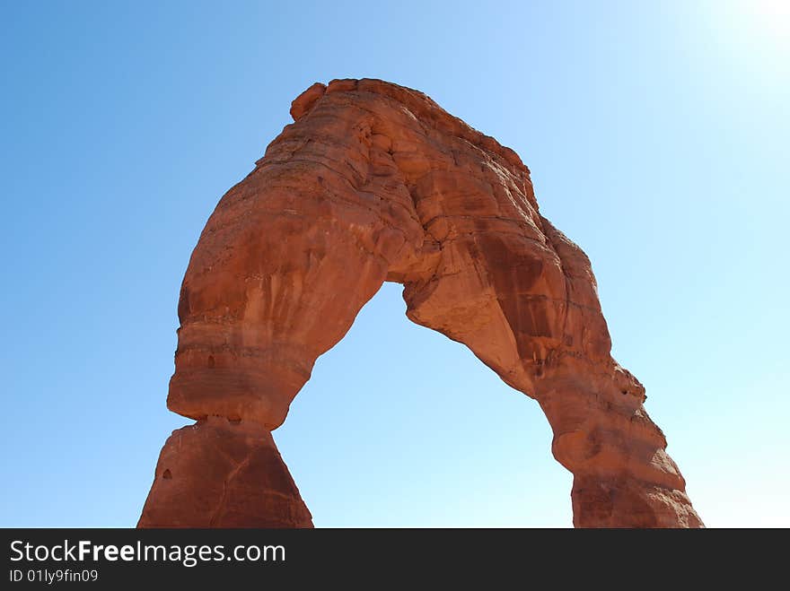 A picture of Delicate Arch in Arches National Park in the bright sun.