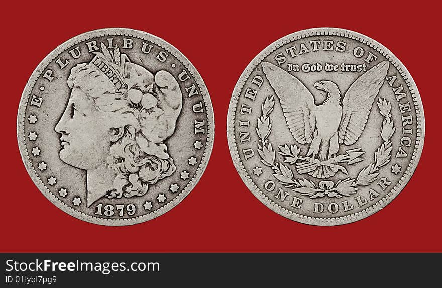 A closeup of the obverse and reverse of a US 1879 Morgan silver dollar with red background. A closeup of the obverse and reverse of a US 1879 Morgan silver dollar with red background.