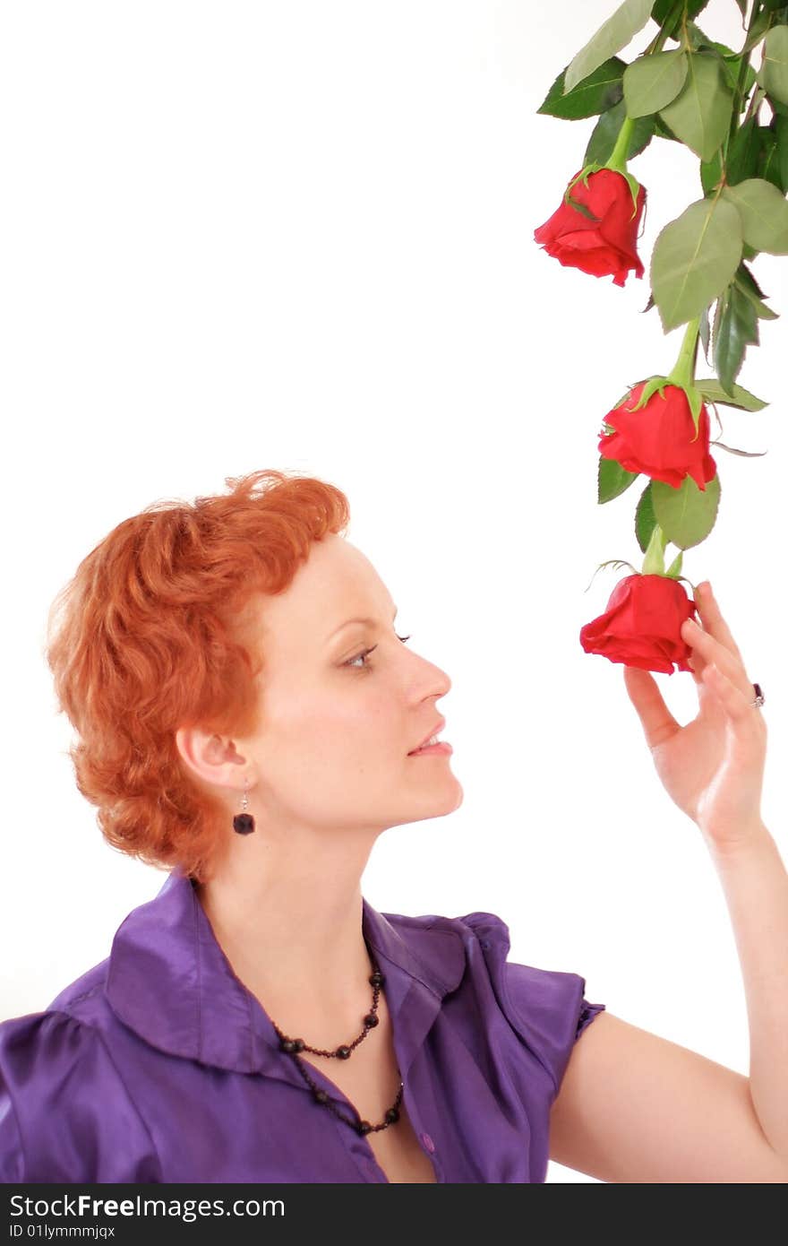 Nice red-hair woman with fresh red roses over white. Nice red-hair woman with fresh red roses over white