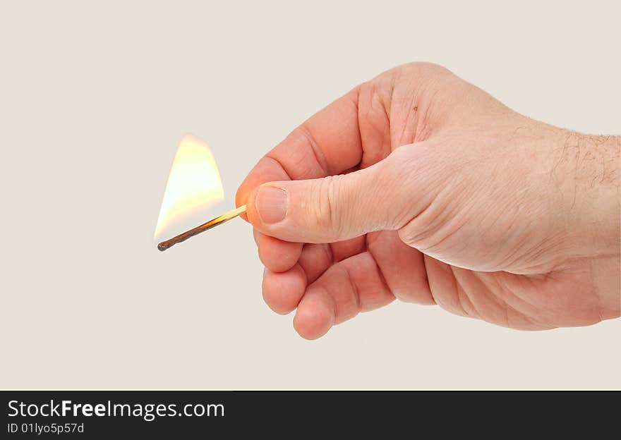 Hand holding a burning match