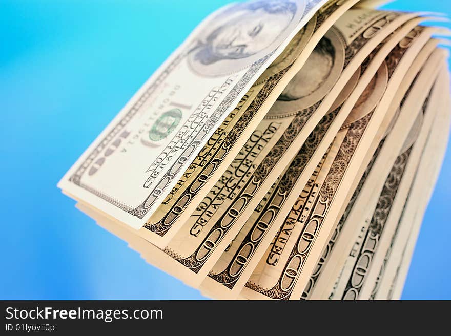 Stacks of US dollar bills in blue  background. Stacks of US dollar bills in blue  background