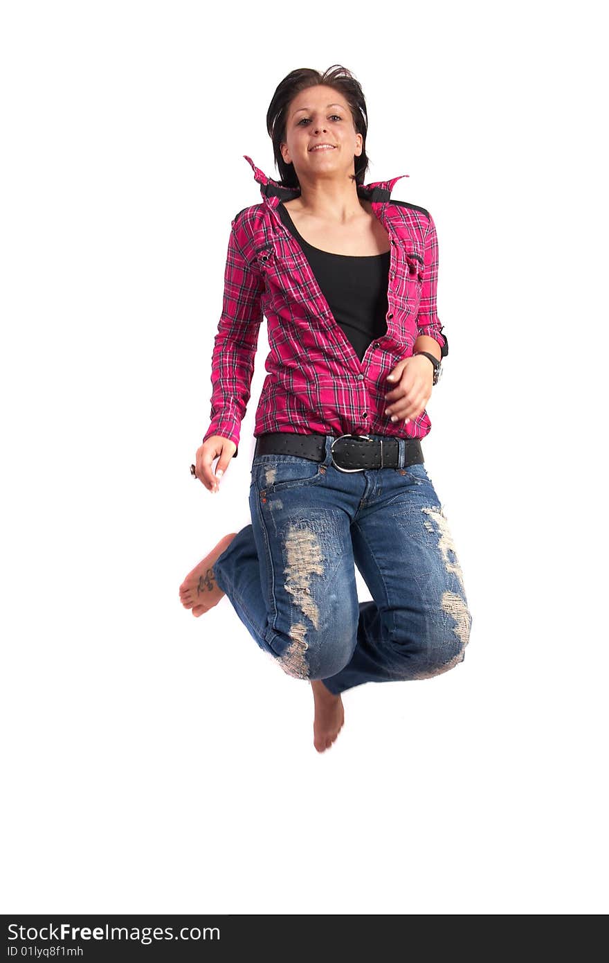 Portrait of a young woman wearing a pink shirt and ripped blue jeans. She is jumping in the air. Slight motion bluriness is intended. Portrait of a young woman wearing a pink shirt and ripped blue jeans. She is jumping in the air. Slight motion bluriness is intended.